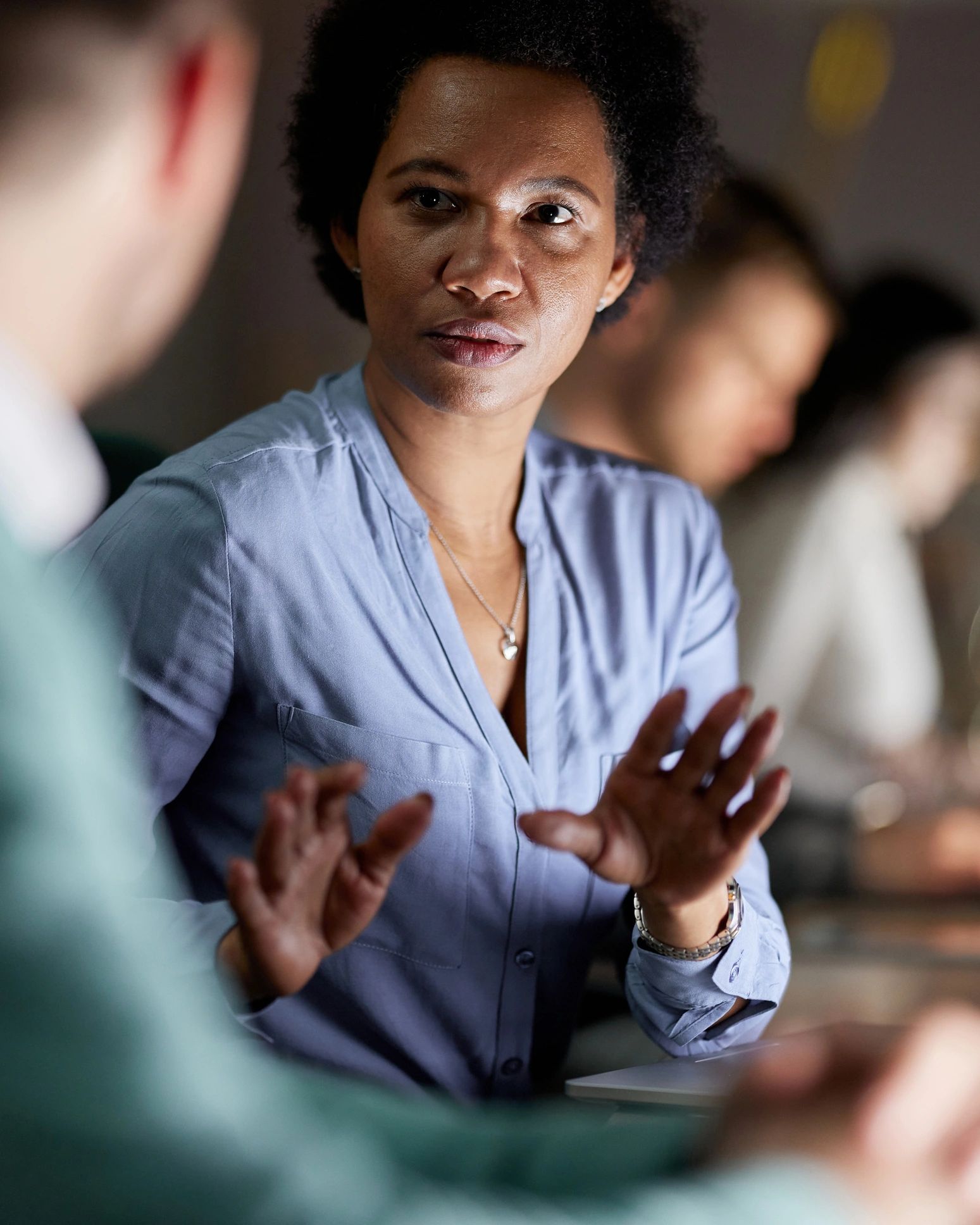 Black business leader in conversation with a colleague
