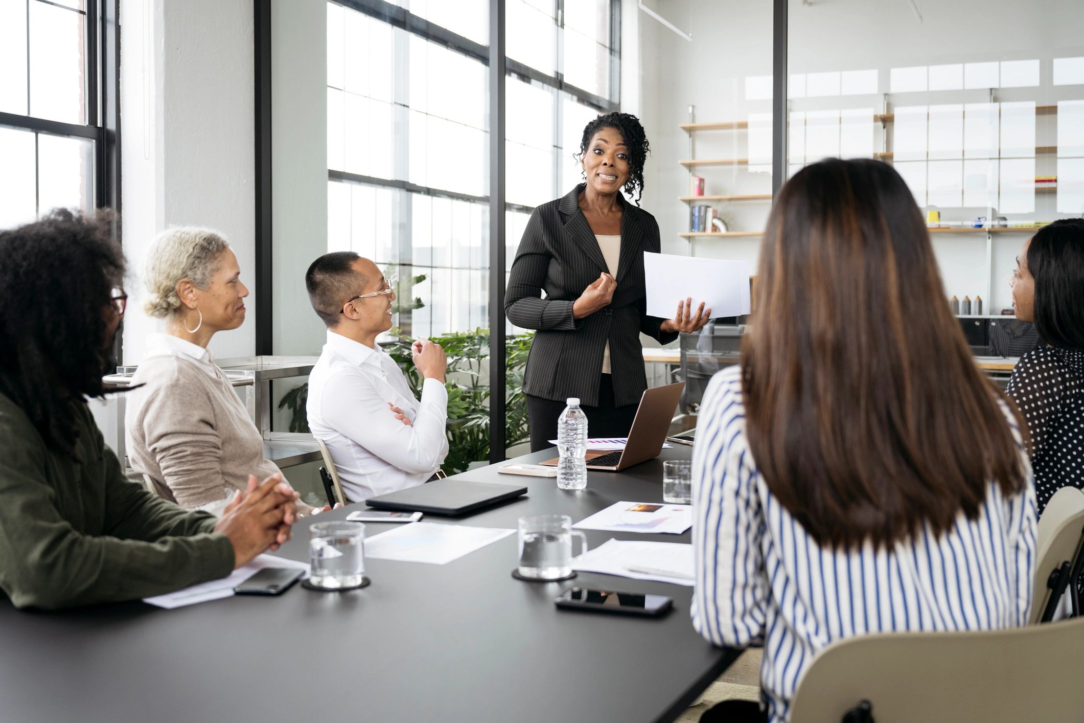 Black executive facilitating a discussion with colleagues
