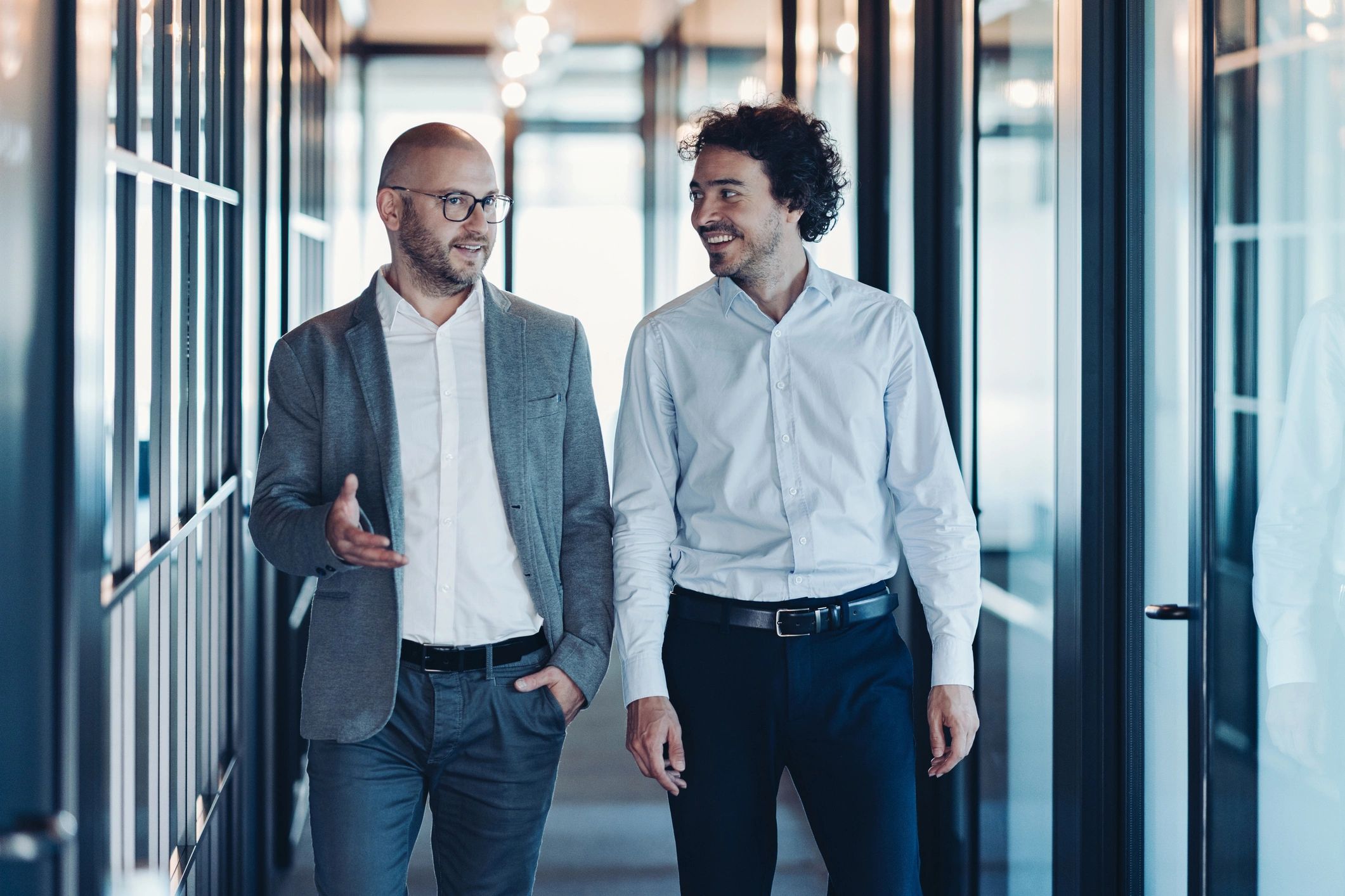 Two colleagues walking forward together in conversation
