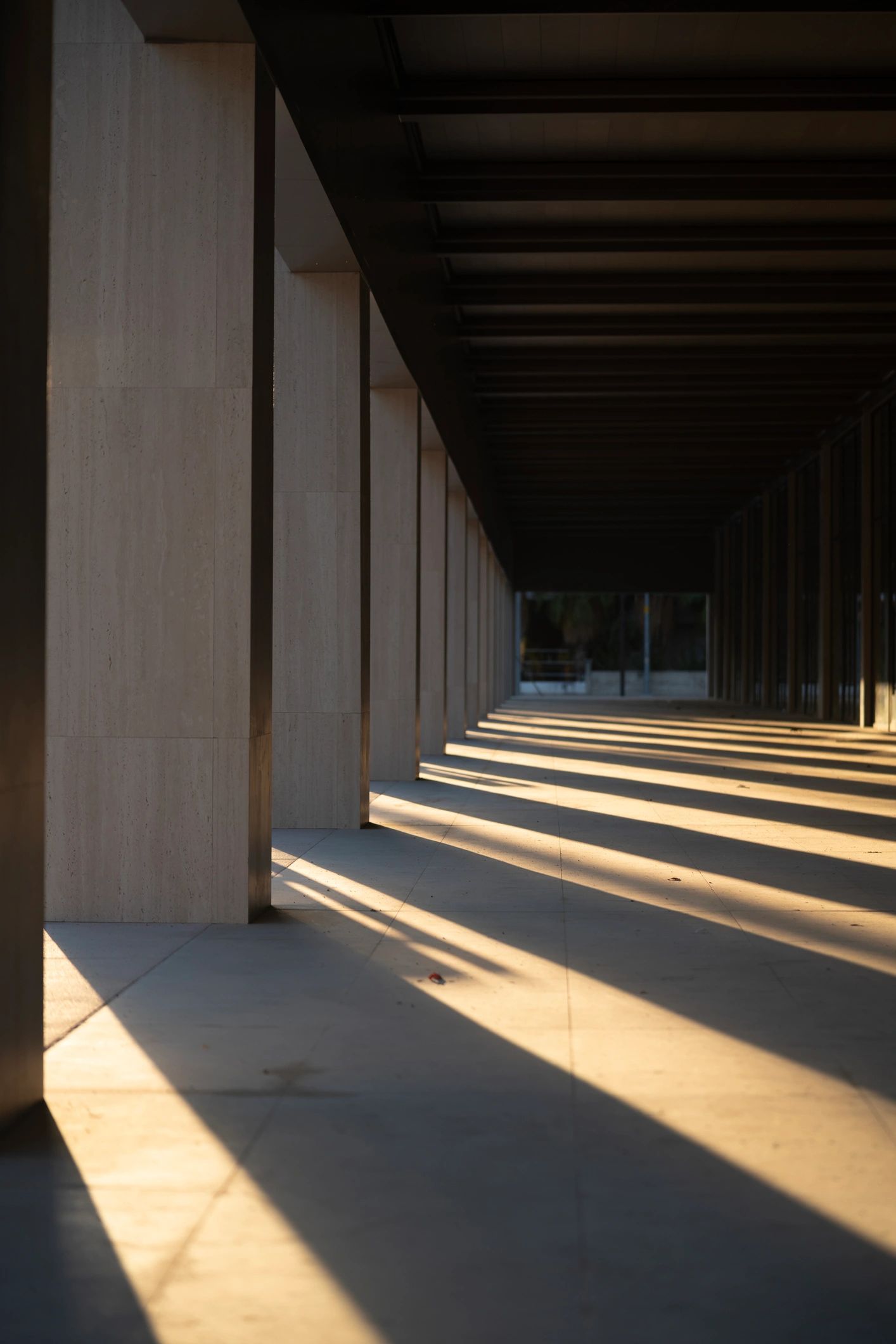 Concrete columns and deep shadows creating a sense of direction and progression